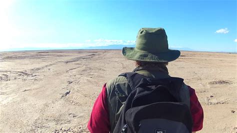 Man Walking Off Into Distance Desert Stock Footage Video 1435216