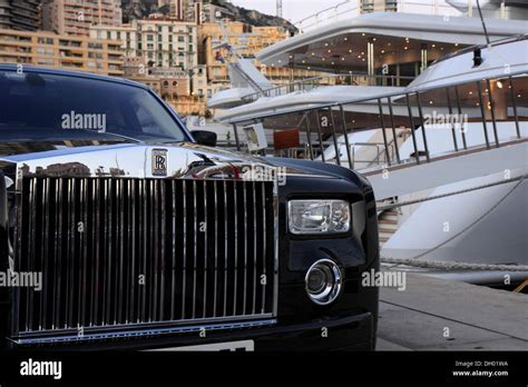 Rolls Royce In Front Of Luxury Yachts In The Harbor Of La Condamine