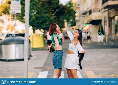 Happy Meeting Of Two Friends Hugging In The Street Stock Photo Image