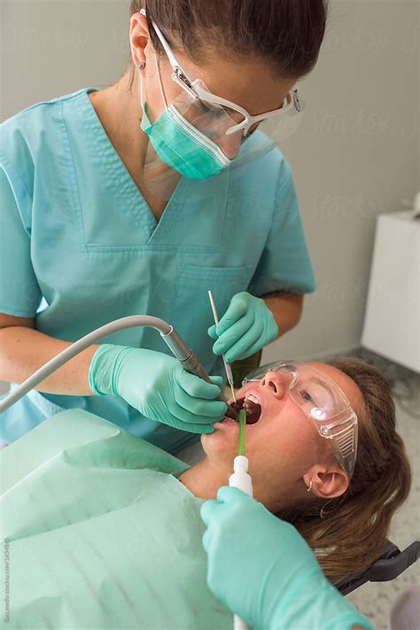 portrait of female orthodontist treating patient in dental office by stocksy contributor ibex