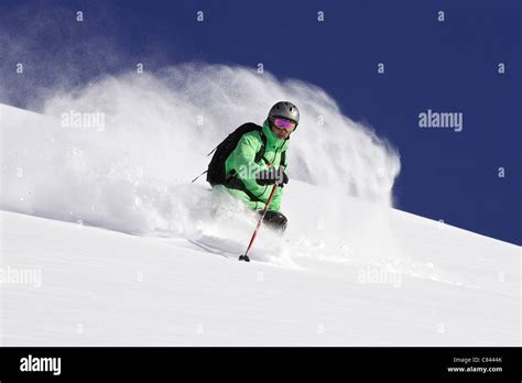 Skier On Snowy Mountain Slope Stock Photo Alamy