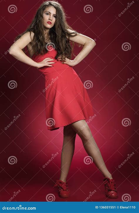 Sensual Beautiful Woman Posing In Red Dress Girl With Long Curly Hair