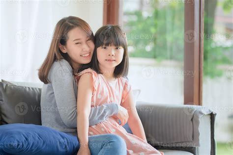 Asian Mother Feel Hapiness During Hug Her Cute Babe With Love And Care At Home Stock