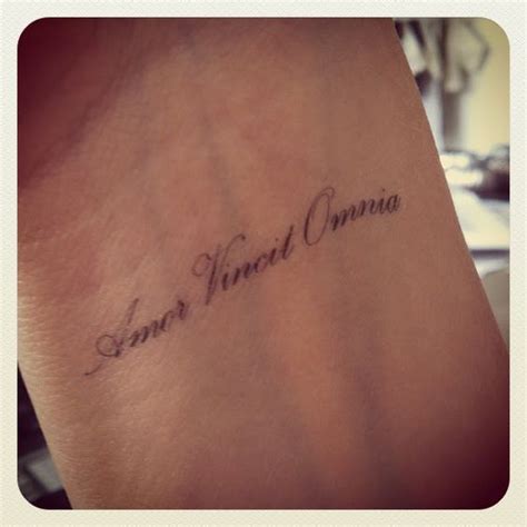 amor vincit omnia love conquers all in latin wrist tattoo tattoo quotes tattoos small