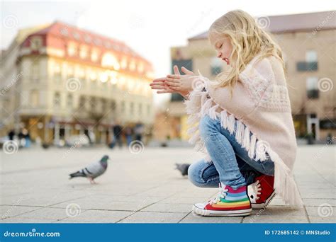 Cute Little Girl Feeding Birds On Spring Day Child Feeding Pigeons And