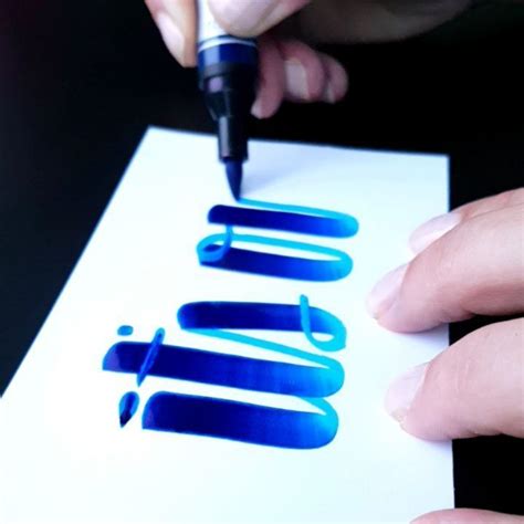 A Person Is Writing On A Piece Of Paper With A Fountain Pen And Some Ink