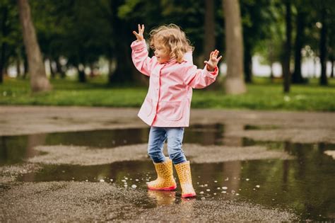 Free Photo Cute Little Girl Jumping Into Puddle In A Rainy Weather