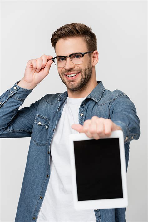 유토이미지 Smiling Man In Eyeglasses Showing Digital Tablet With Blank Screen On Blurred Foreground