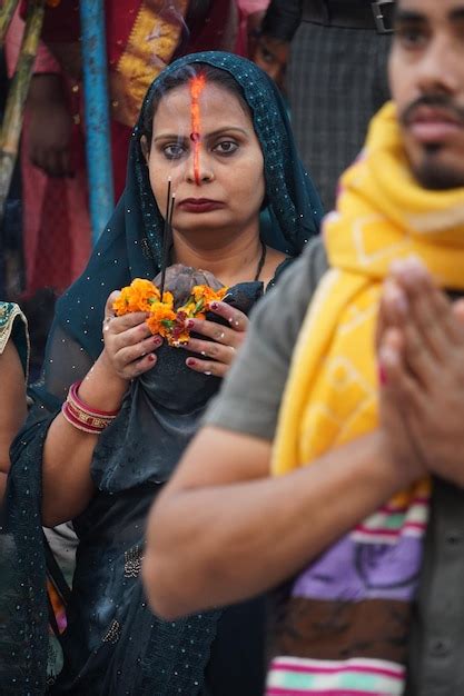 Premium Photo Chhath Puja Indian Hindu Female Devotee Performing Rituals Of Chhath Puja