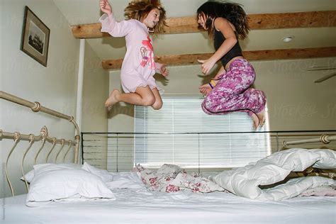 Young Girls Jumping On Bed In Pajama By Stocksy Contributor Raymond Forbes Llc Stocksy