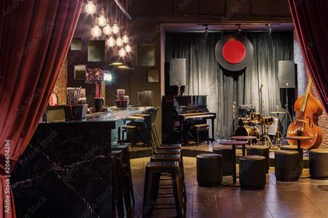 Modern Jazz Bar Interior Design Stage With Black Piano And Cello Lamps Above Bar Counter Stock