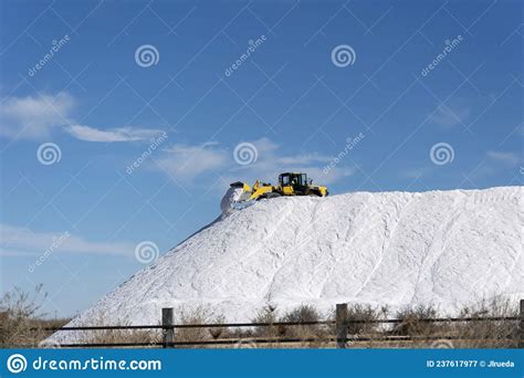 Excavator Working On Top Of A Huge Pile Of Salt In The Salt Flats