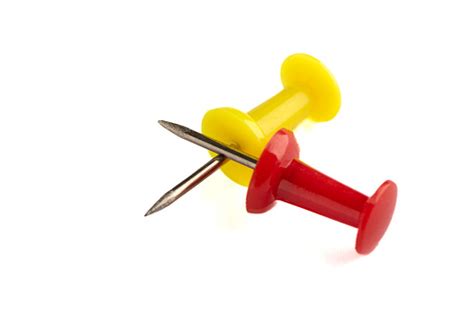 Closeup Of Yellow And Red Push Pins Isolated On White Background Stock