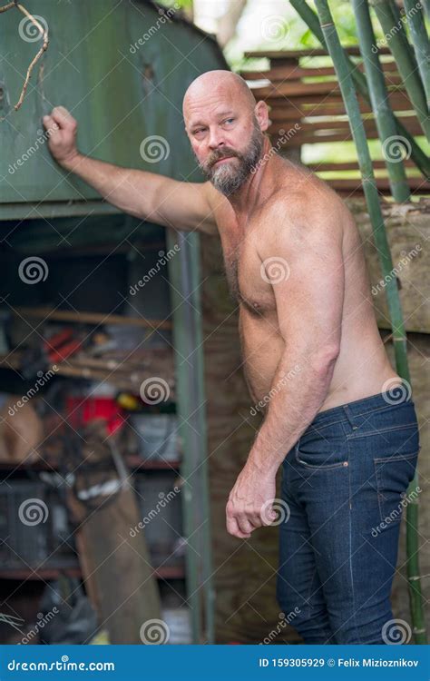 shirtless guy leaning on a shed in his backyard stock image image of light chest 159305929