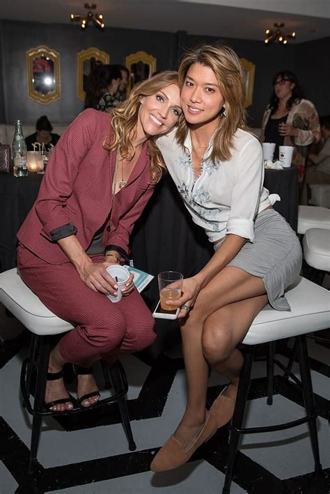 Two Women Sitting Next To Each Other At A Party