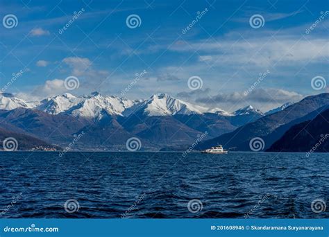 Italy Bellagio Boat On Lake Como With Snow Covered Peaks Background