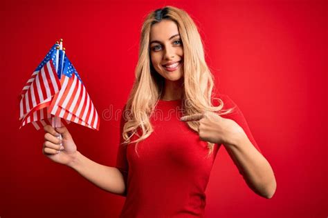 Beautiful Blonde Patriotic Woman Holding United States Flags Celebrating Independence Day With