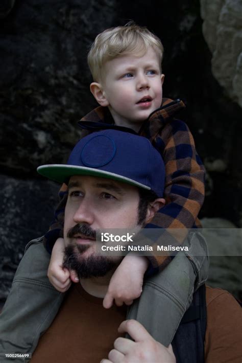 Closeup Portrait Of Dad And Son Sitting On Shoulders High Quality Photo