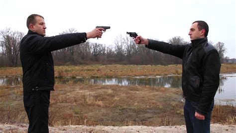 Two Men Pointing Guns At Each Other Stock Footage Video 2130347