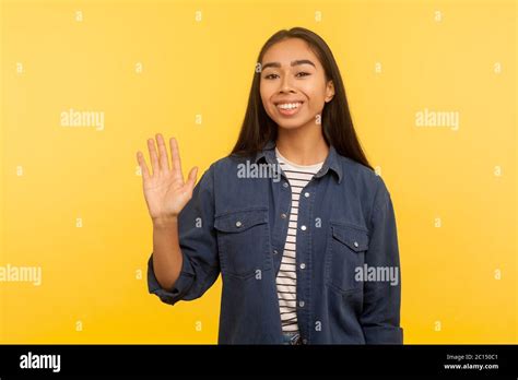 Hi Welcome Portrait Of Friendly Happy Girl In Denim Shirt Waving Hand