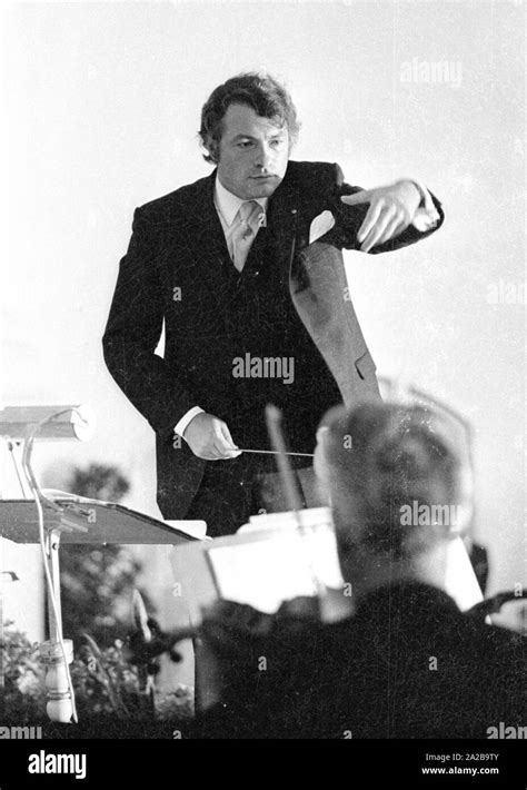 A Conductor Gestures And Leads The Musicians With Baton At A Concert