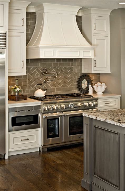 By adding grey subway tiles to your kitchen backsplash, you will be able to spruce your kitchen up and make your. Gray and White Kitchen with Herringbone subway tile backsplash. Potfiller. Thermador 48" range ...
