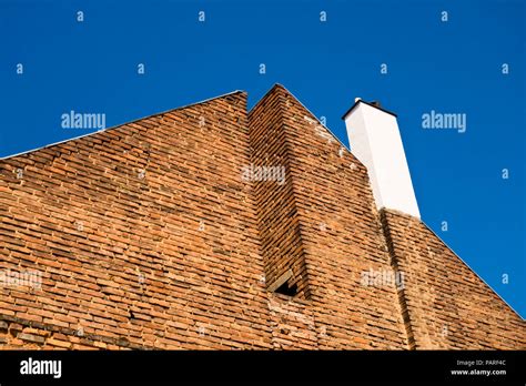 Graphical Angled View Of A Red Bricks House With White Chimney And Blue