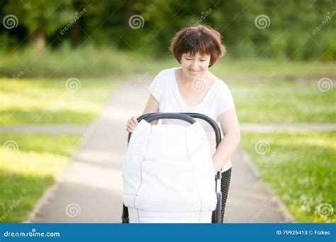 Grandmother Walking With A Baby Stroller In Park Stock Image Image Of