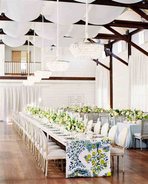 A Long Table Is Set Up With White And Blue Linens