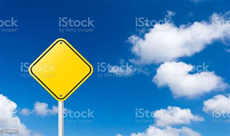 Blank Yellow Traffic Sign With Blue Sky Background Stock Photo