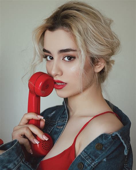 Woman In Red And Black Tank Top Holding Red Telephone Photo Free