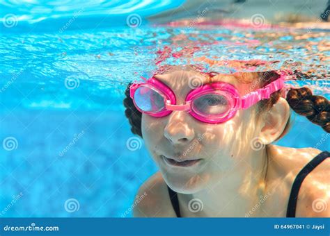 Child Swims In Pool Underwater Happy Active Girl In Goggles Has Fun In