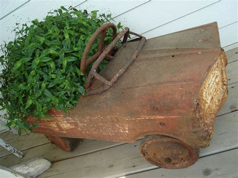 Get money for your junk car and know that it is being reused to help others repair their vehicles and recycled to help the earth. an old rusted out peddle car as a planter (With images ...