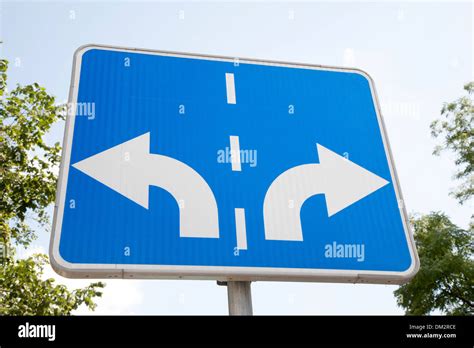 Traffic Sign With Two Arrows Pointing In Different Directions Stock