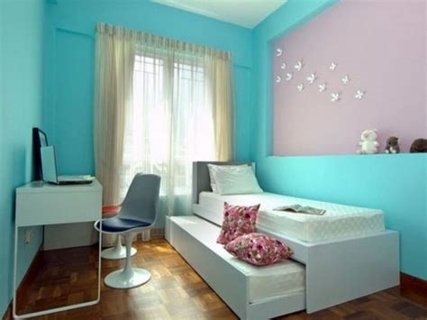 A Bedroom With Blue Walls And White Furniture In The Corner Including