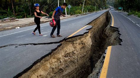 Psbattle Two People Looking At Recent Fissure On A Road Caused By
