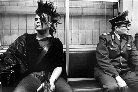 Punk And A Member Of The Volkspolizei Sitting Together In The Ubahn