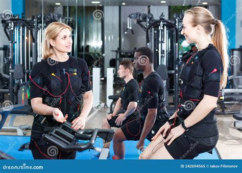 Two Fit Woman Communicating During Electric Muscle Stimulation Workout