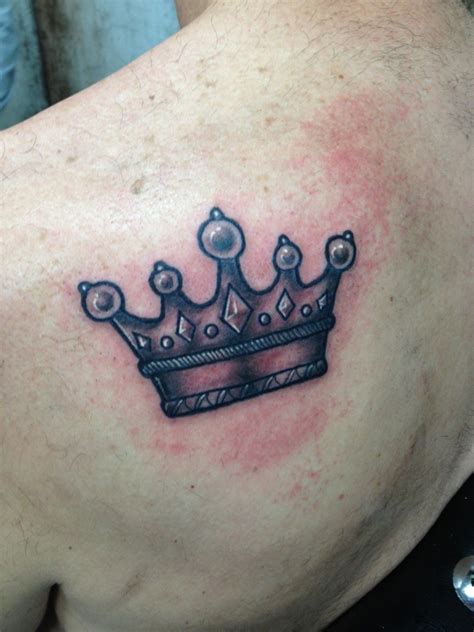 An artist is applying a tattoo to his client's arm. Crown Tattoos Designs, Ideas and Meaning | Tattoos For You