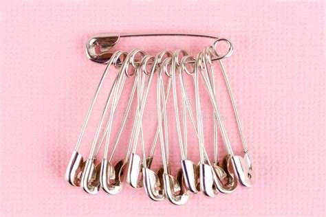 Set Of Safety Pins Lying On Pink Paper Stock Photo Image Of Safety