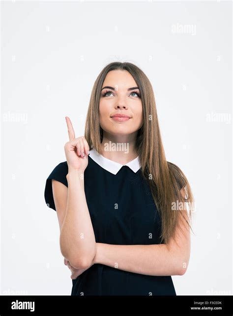Portrait Of A Pretty Thoughtful Woman Pointing Finger Up At Copyspace