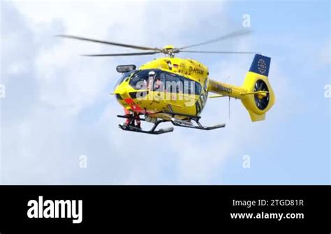 Yellow Adac Rescue Helicopter Hovering In The Air In Flight Shot Of An