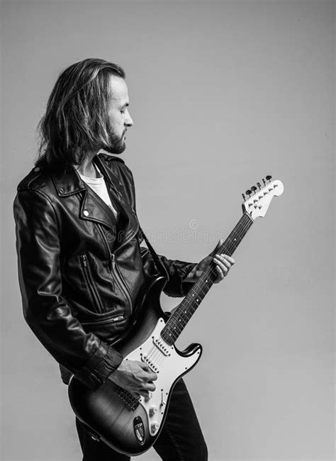 Bearded Rock Musician Playing Electric Guitar In Leather Jacket Rock