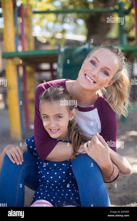 Portrait Of Happy Mother And Daughter Enjoying At Playground Stock