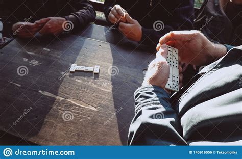 People Playing The Domino Game In The Park Stock Photo Image Of Hands