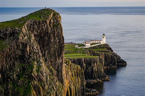 I did a roadtrip last august. A photographer on top a cliff at Neist Point lighthouse in ...