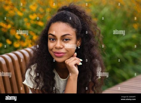Dark Skinned Brunette Female With Loose Wavy Curls African American Hair Outdoor Lifestyle