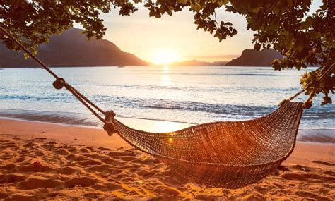Traditional Hammock In The Shade At Sunset On A Calm Tropical Beach