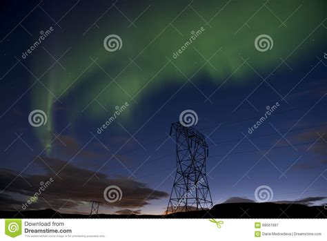 Green Northern Lights On A Blue Night Sky With Stars