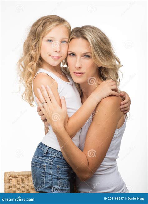 Beautiful Blonde Mother In Singlet And Similar Looking Curly Daughter Together In Studio White